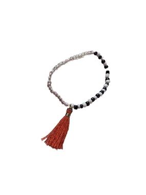 Black & White Beaded Bracelet with Orange Tassel